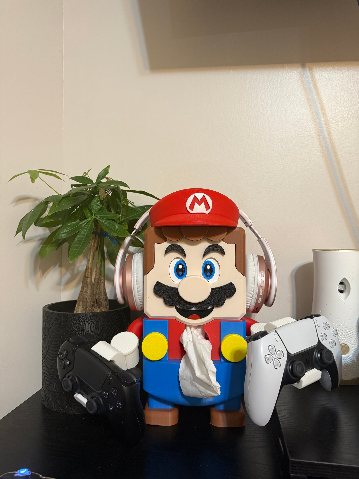 Super Mario tissue box Mario" This Mario comes with a controller holder, you could place a tissue box