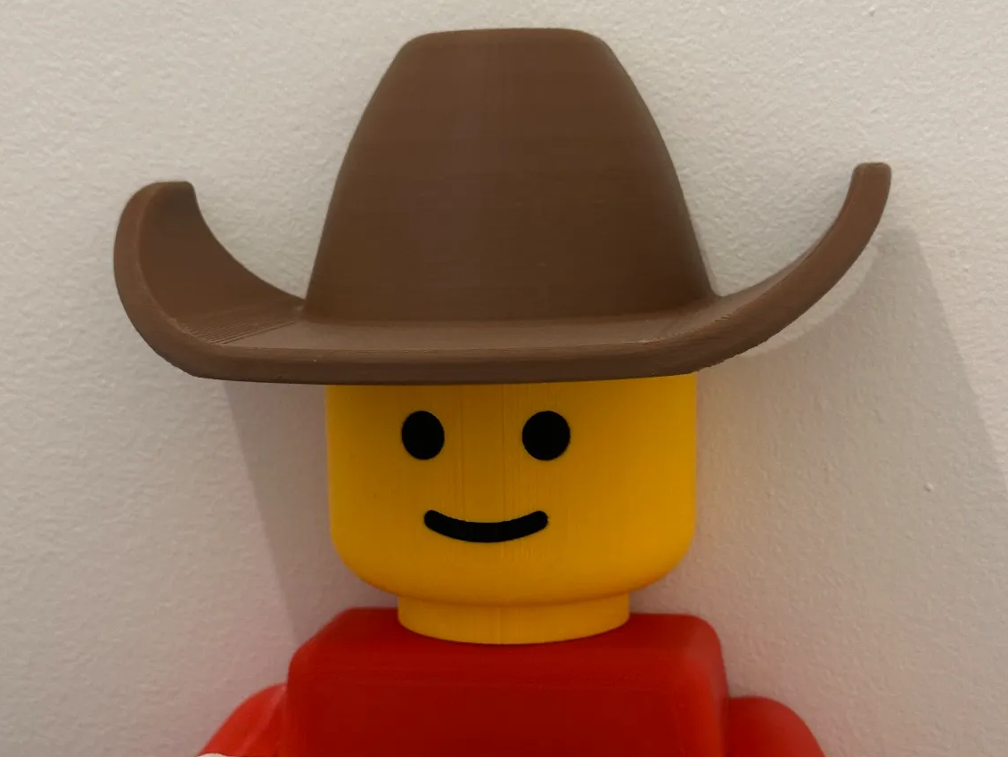 Lego man toilet paper holder come with hair, cowboy hat, tp hat and 2 diferent holder